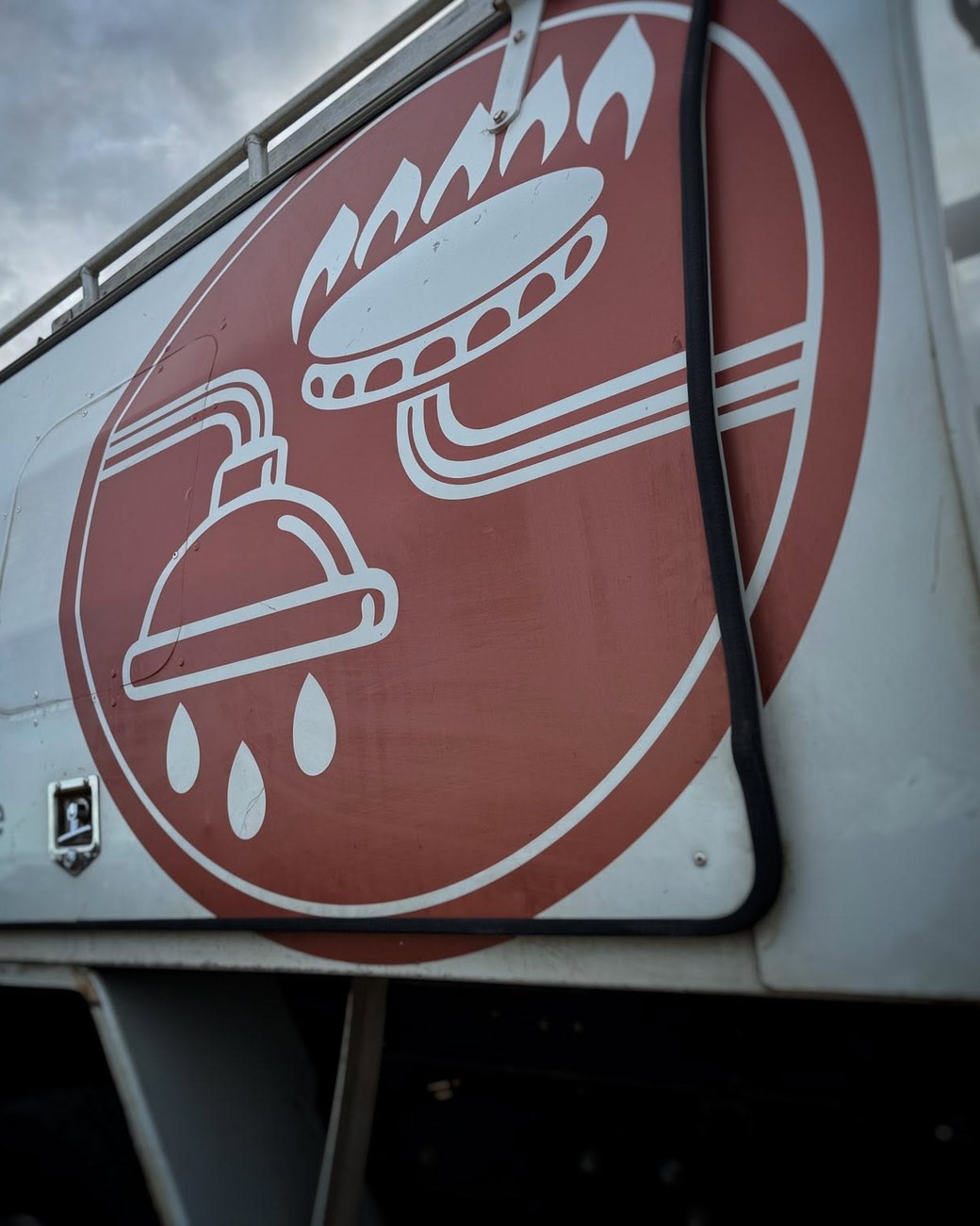The McLennan Plumbing & Gas logo signwritten on the canopy of Tristan’s ute